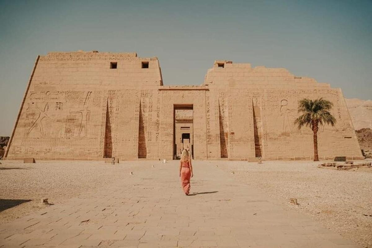 a woman standing in front of a large building