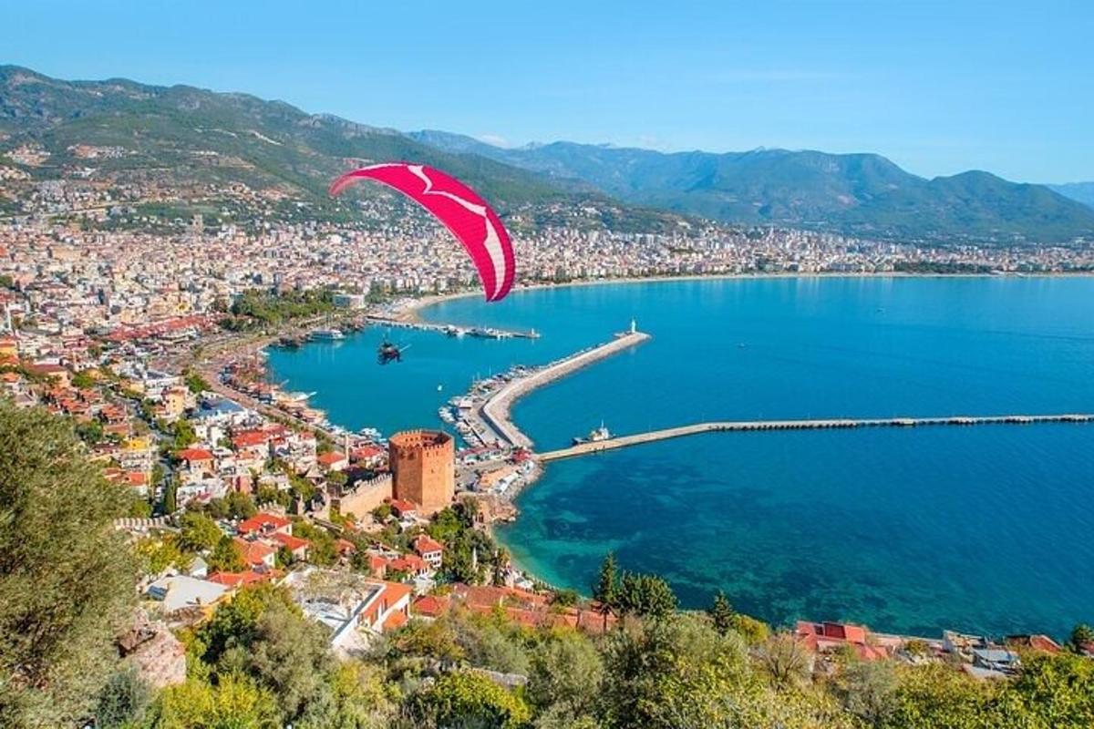 a red kite flying over a body of water
