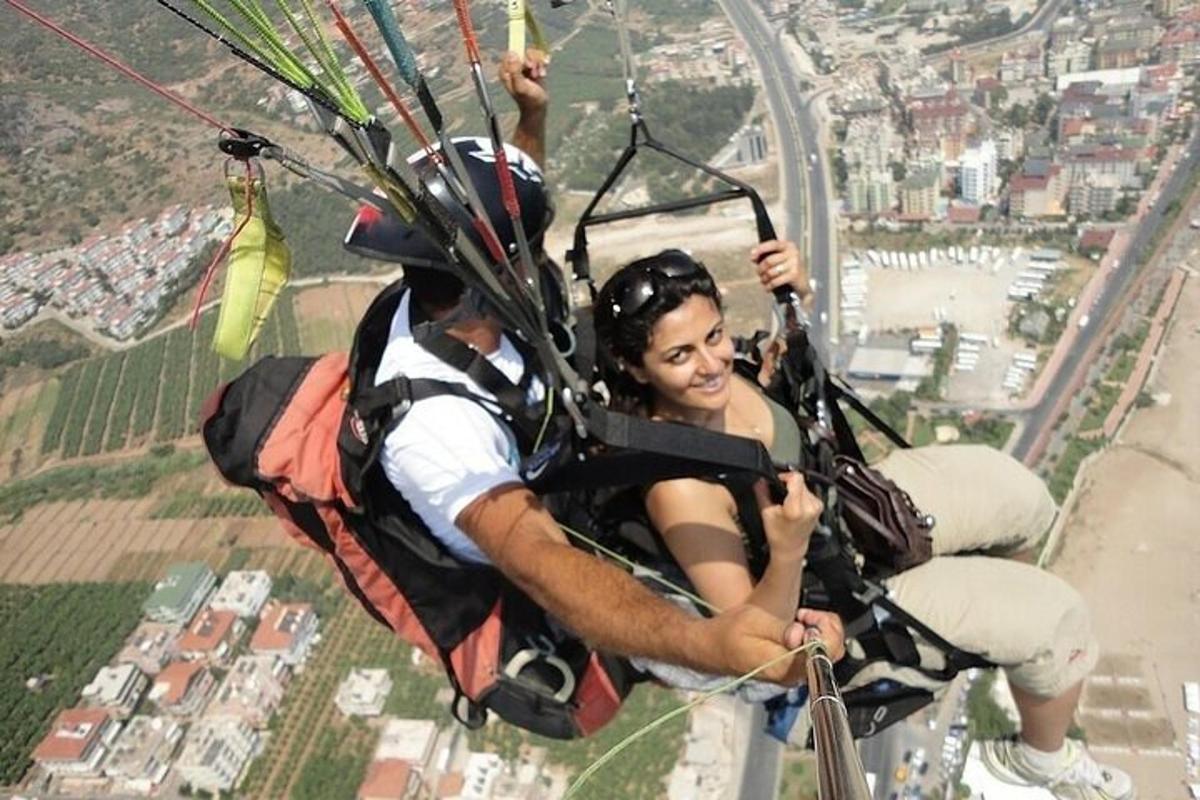 a man and a woman riding in a parachute