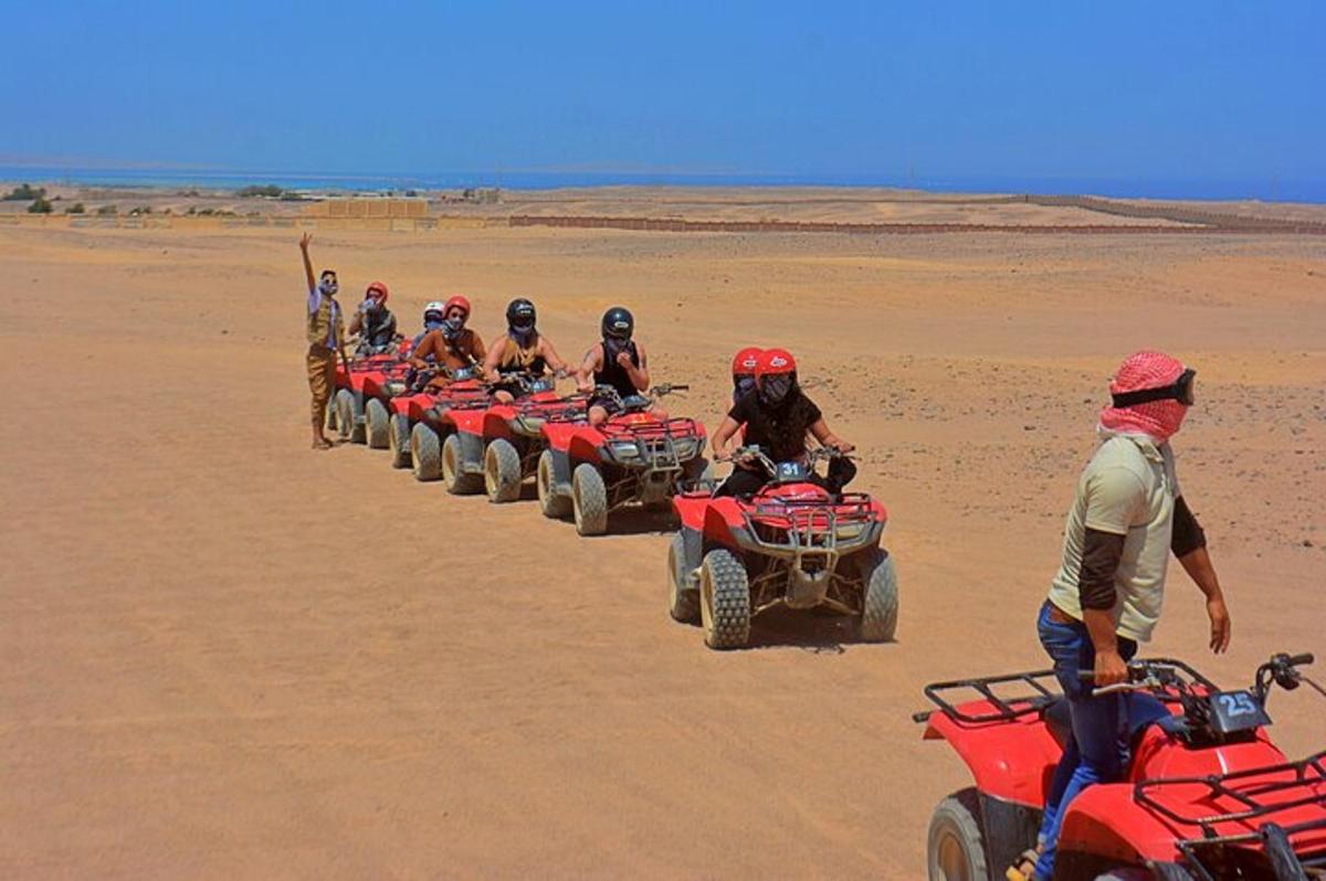 a group of people riding atvs in the desert