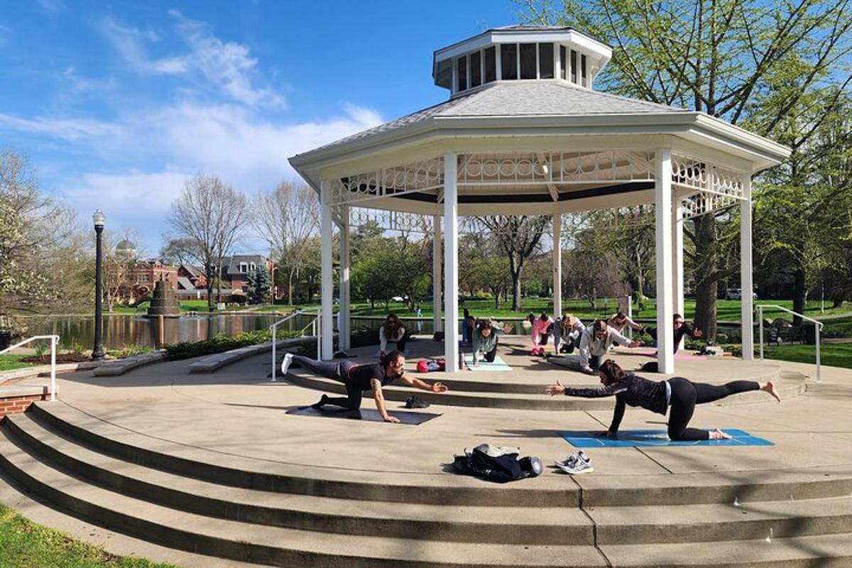 a group of people doing yoga in a gazebo