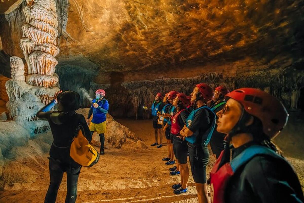 a group of people walking through a cave