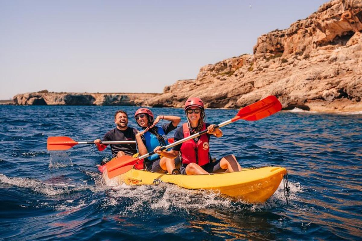 three people in a yellow kayak in the water