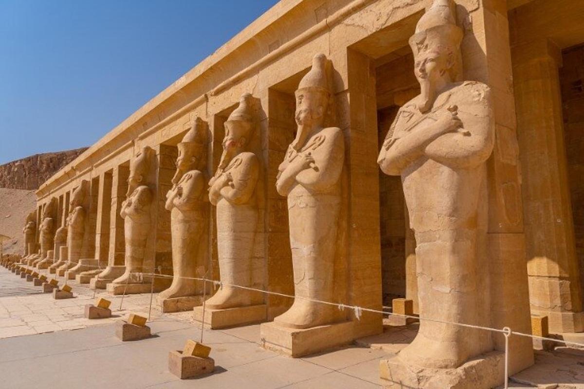 a row of statues on the side of a building
