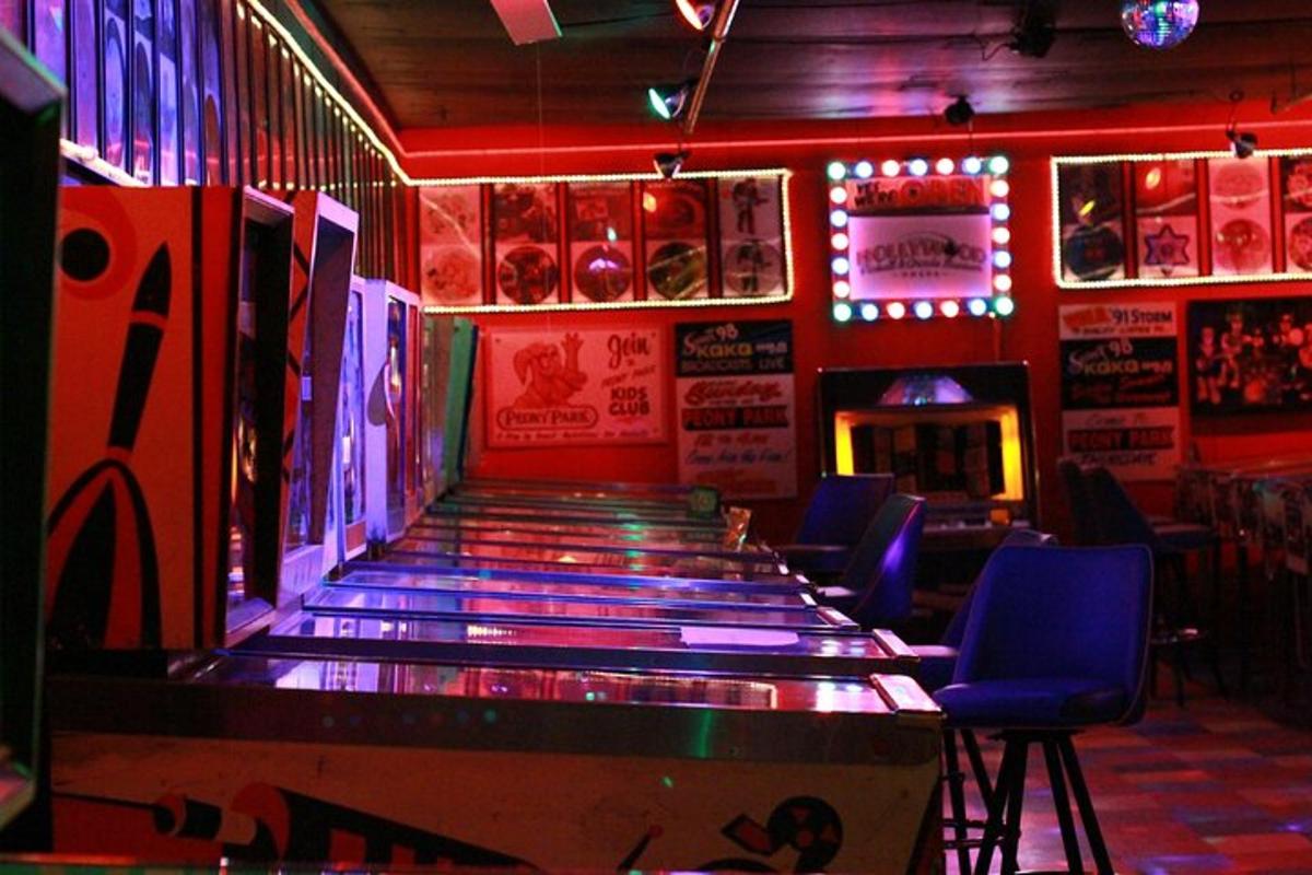 a bar with blue chairs and a dance floor