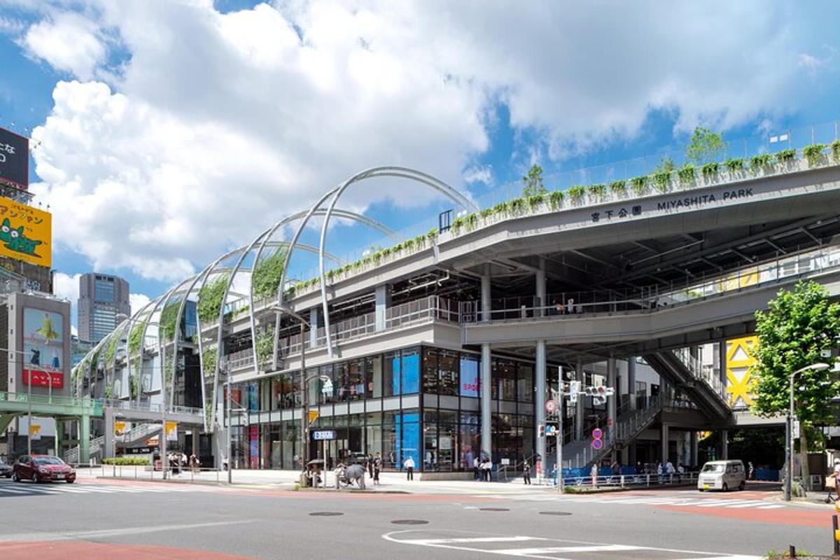 a large building with a curved roof with plants on it