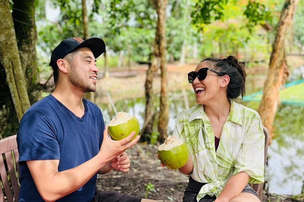 a man and a woman sitting on a bench holding green apples