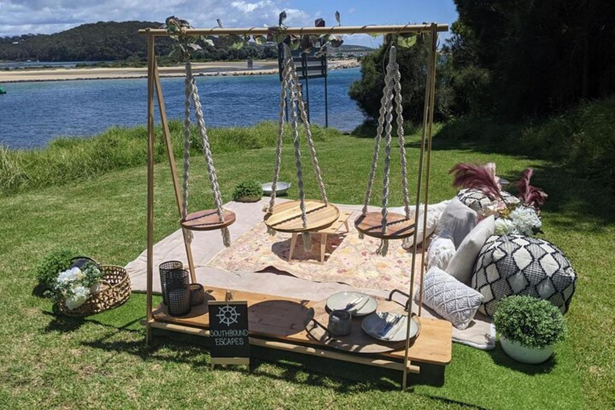 a girl sitting on a swing in the grass