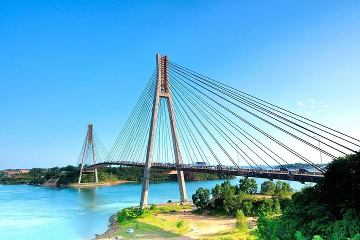 a bridge over the water with a blue sky