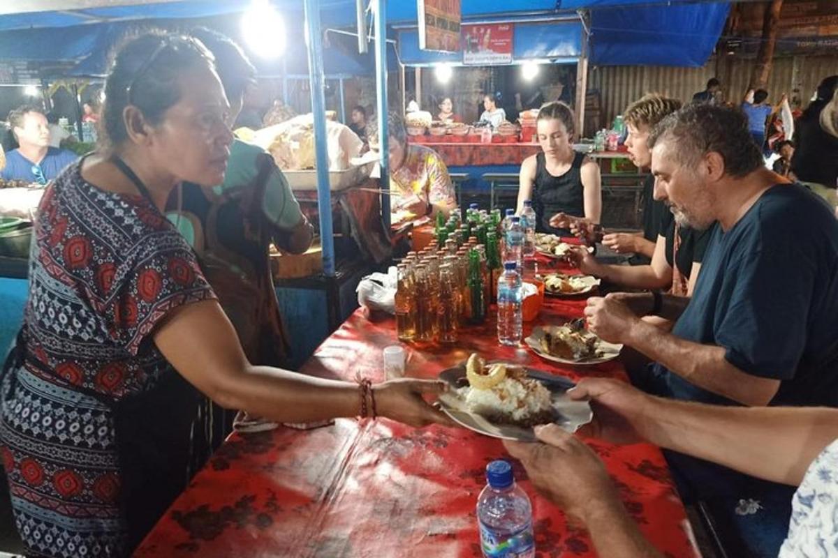 a group of people sitting at a table eating food