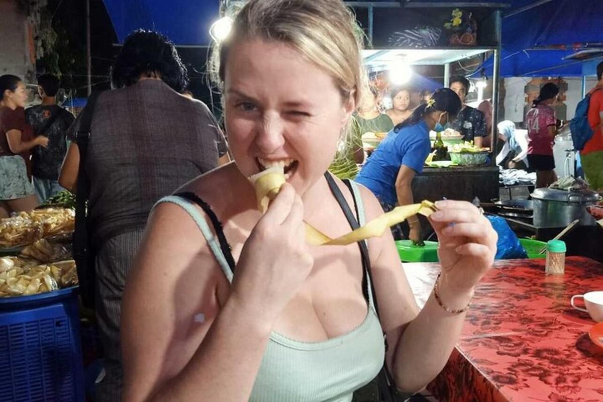 a woman eating a banana in a market