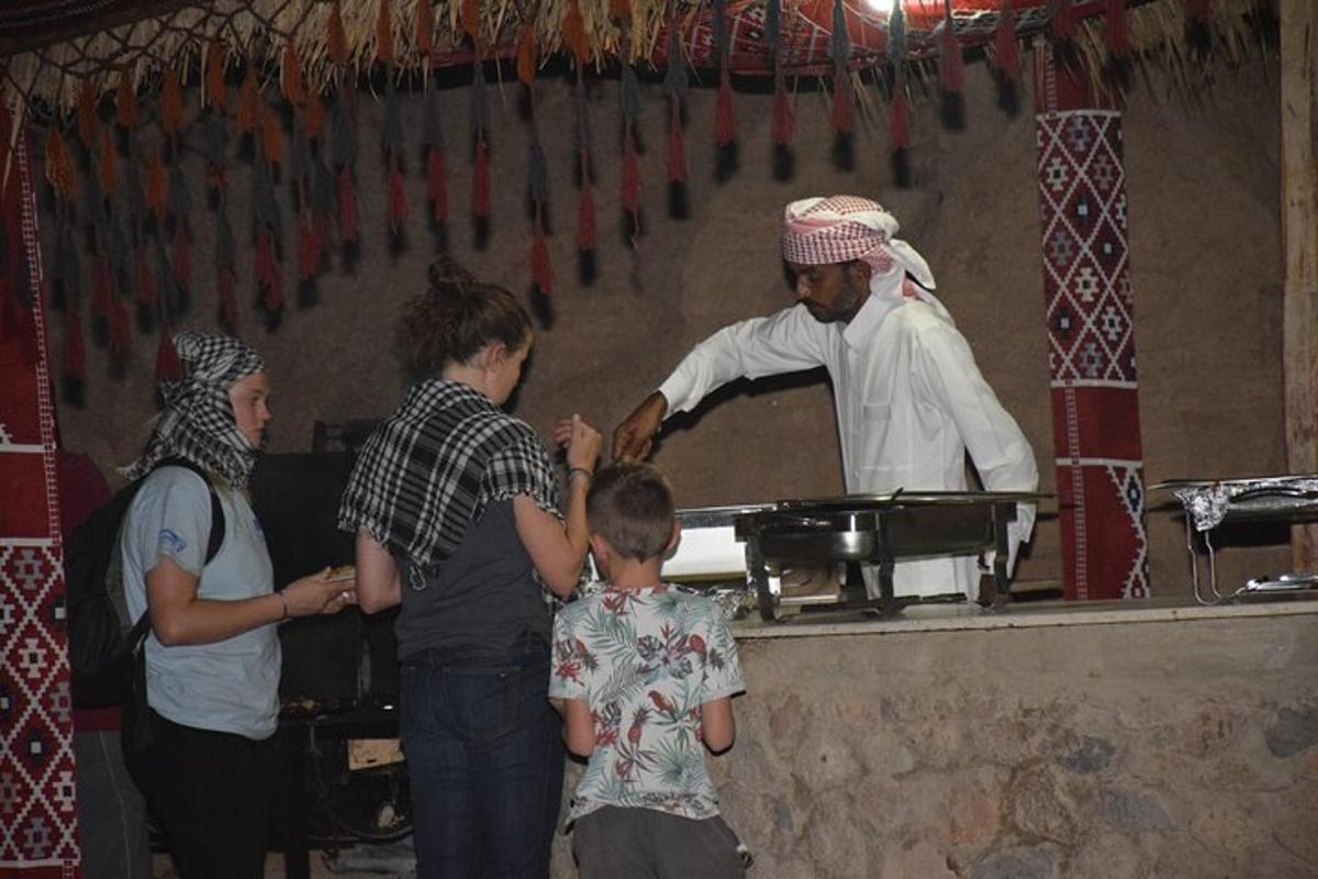 a group of people standing around a chef preparing food