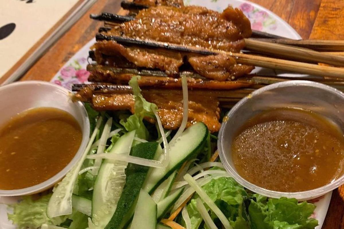 a plate of food with meat and vegetables and dipping sauce