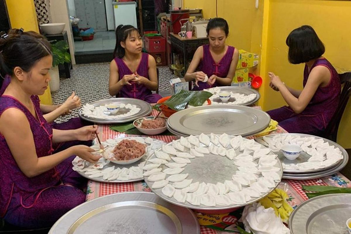 a group of women sitting around a table eating food