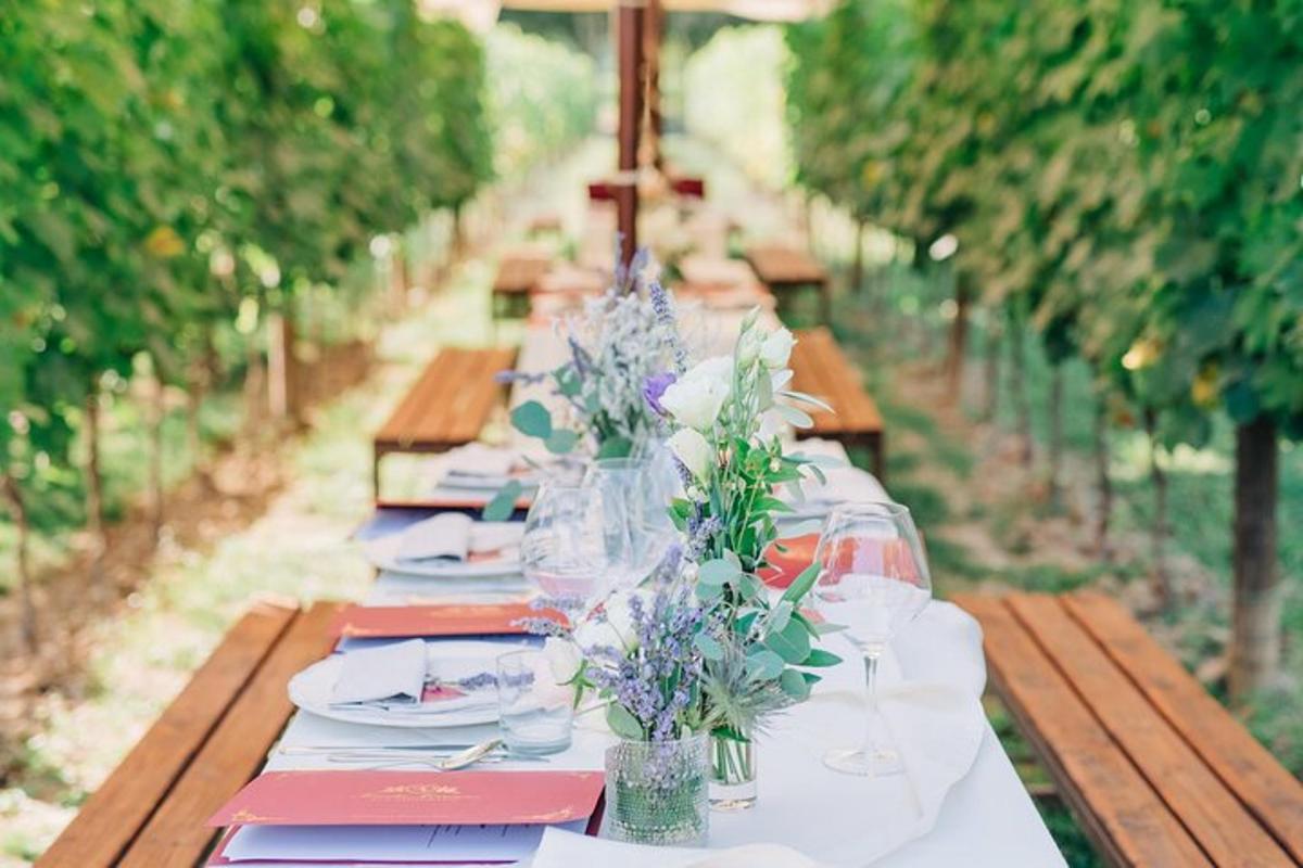 a long table with plates and glasses and flowers