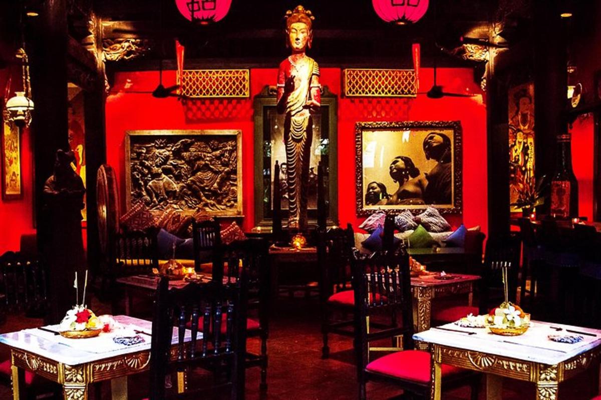 a restaurant with two tables and a statue in a room