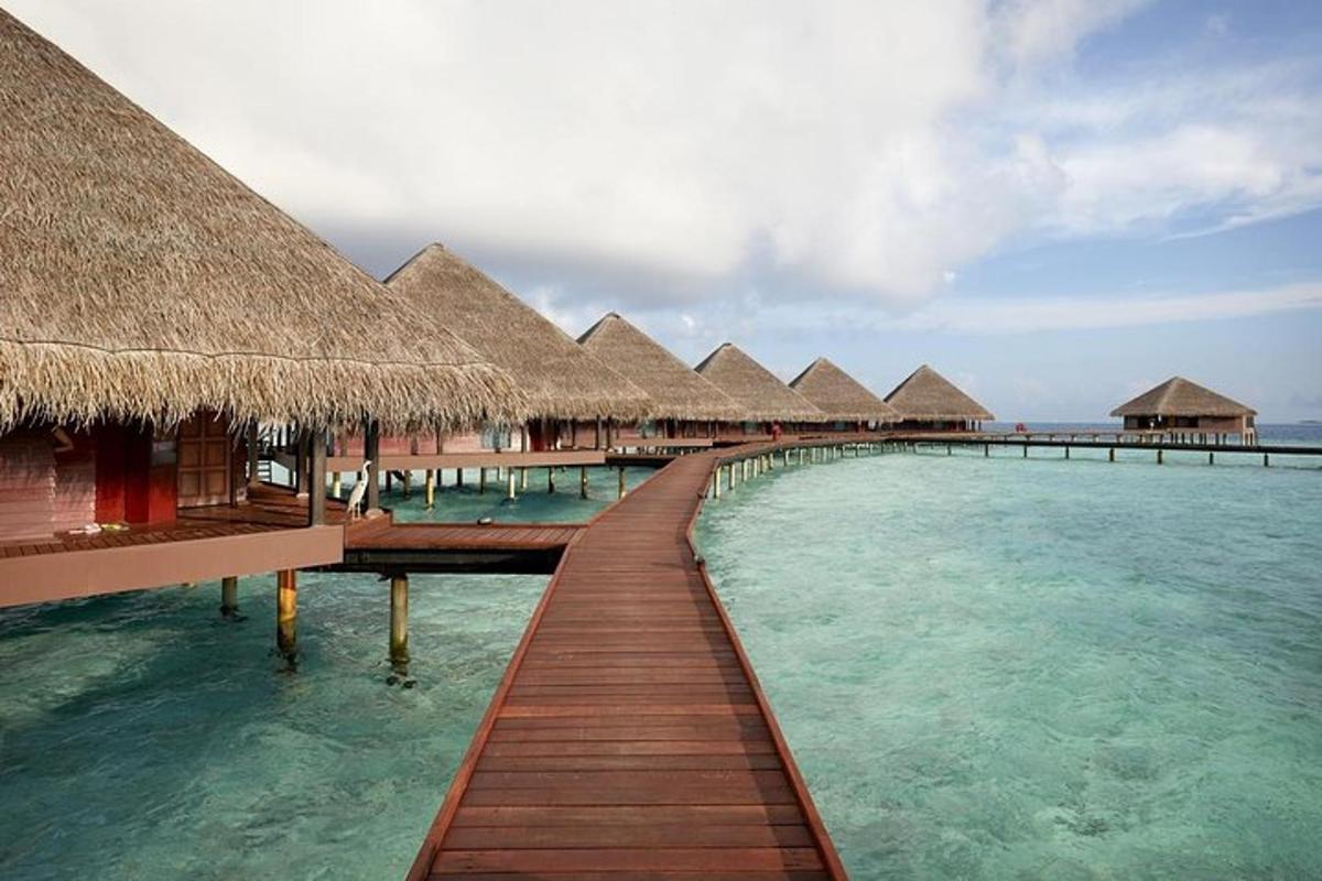 a row of huts on the water in the ocean