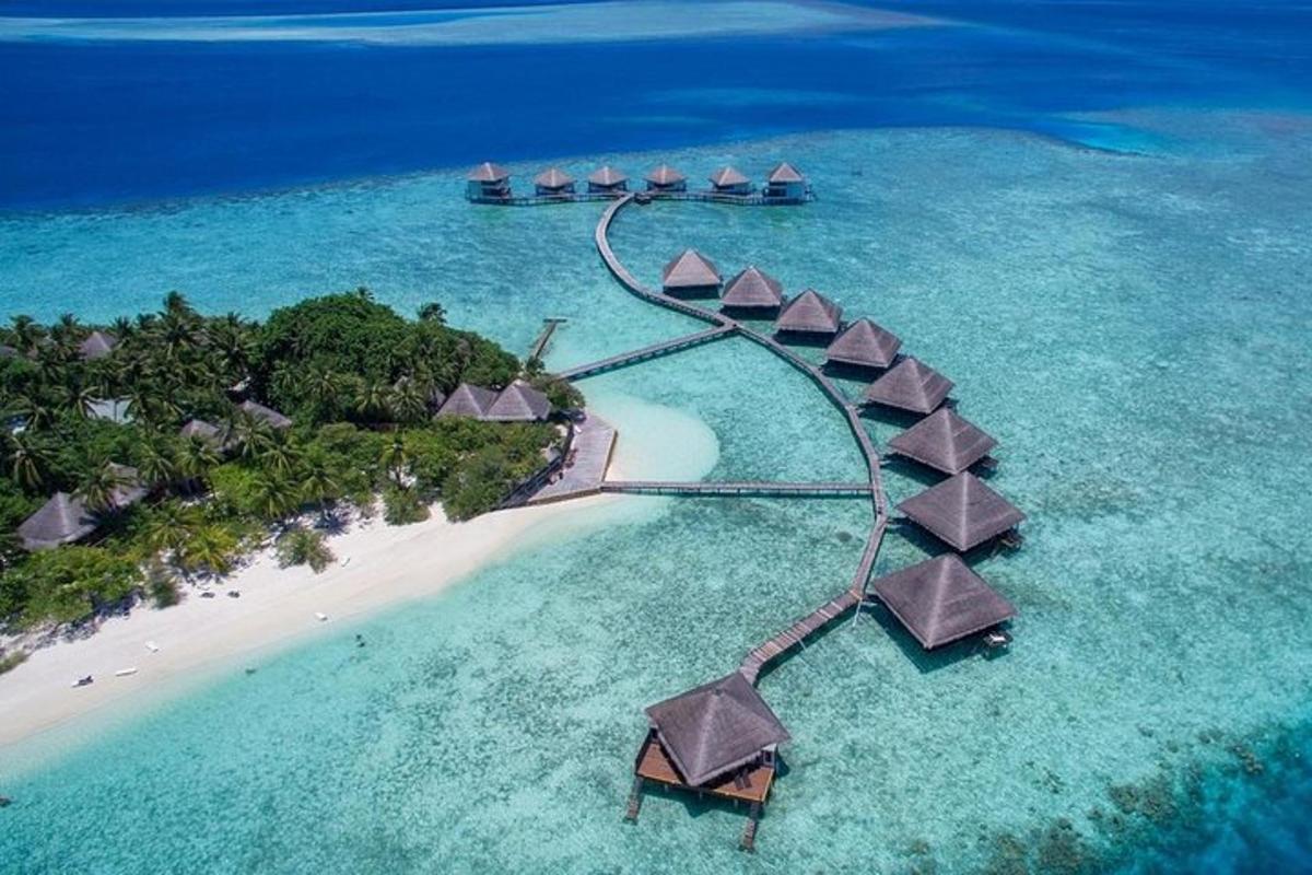 an aerial view of a resort in the ocean