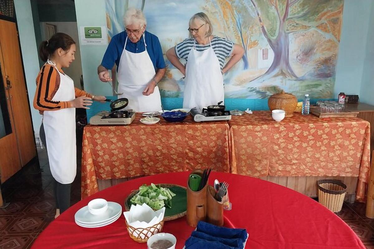 a group of people standing around a table preparing food