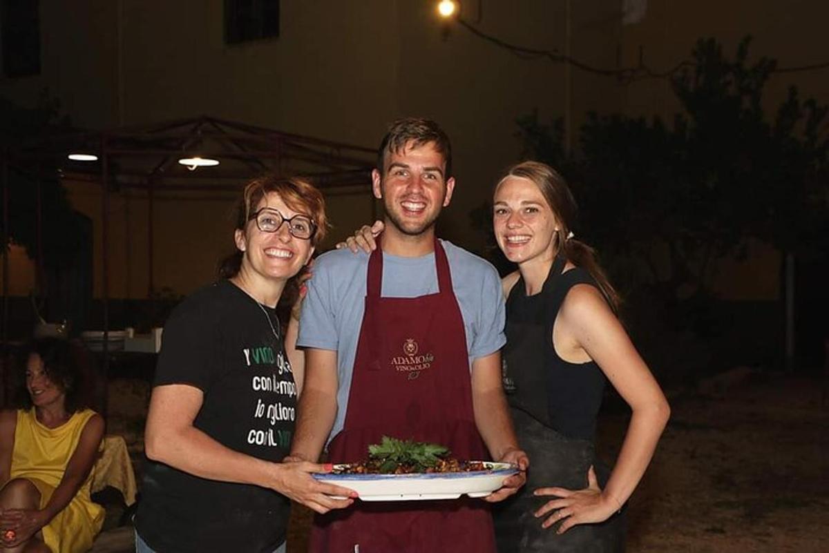 a man and two women holding a plate of food