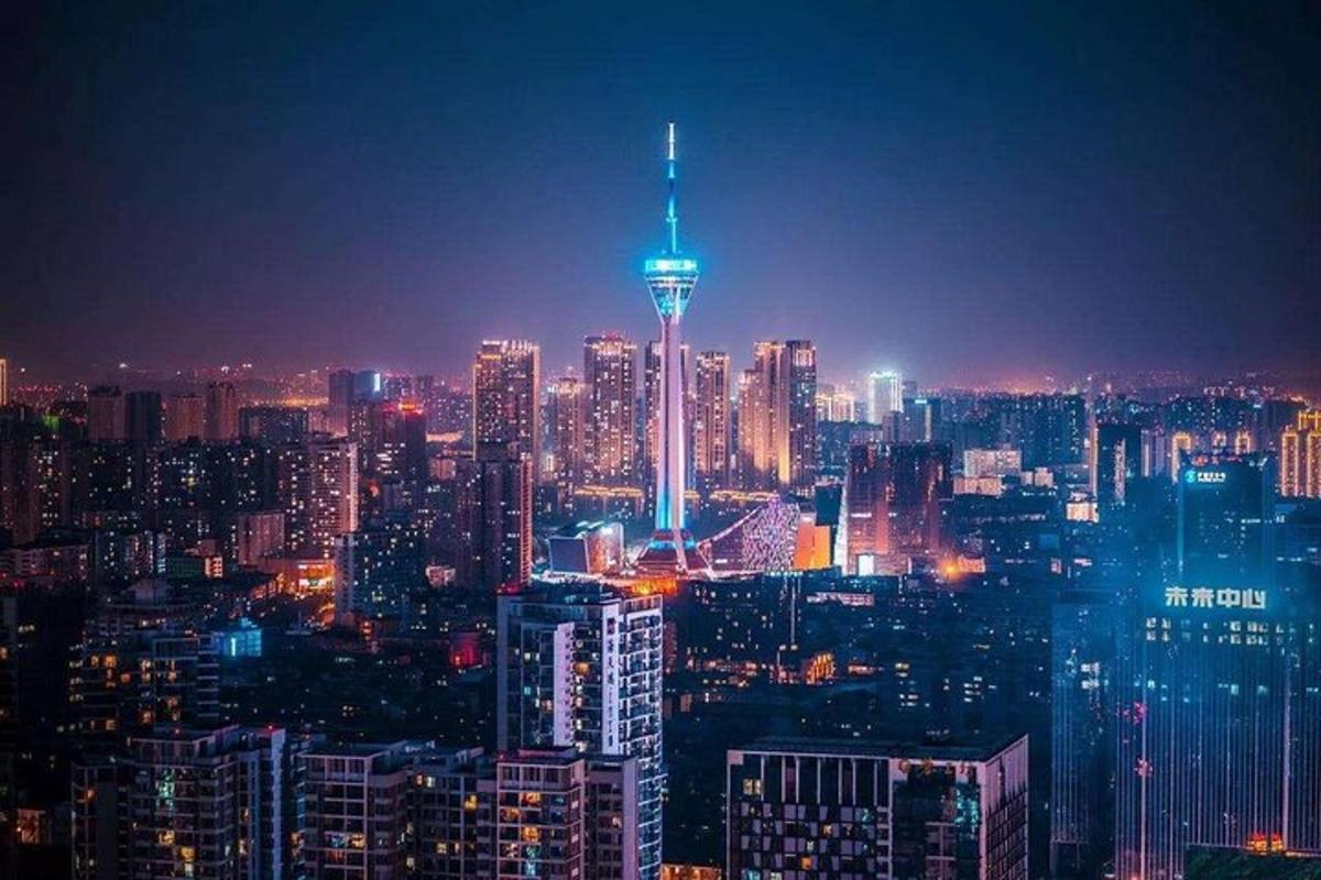a lit up city skyline at night with the space needle