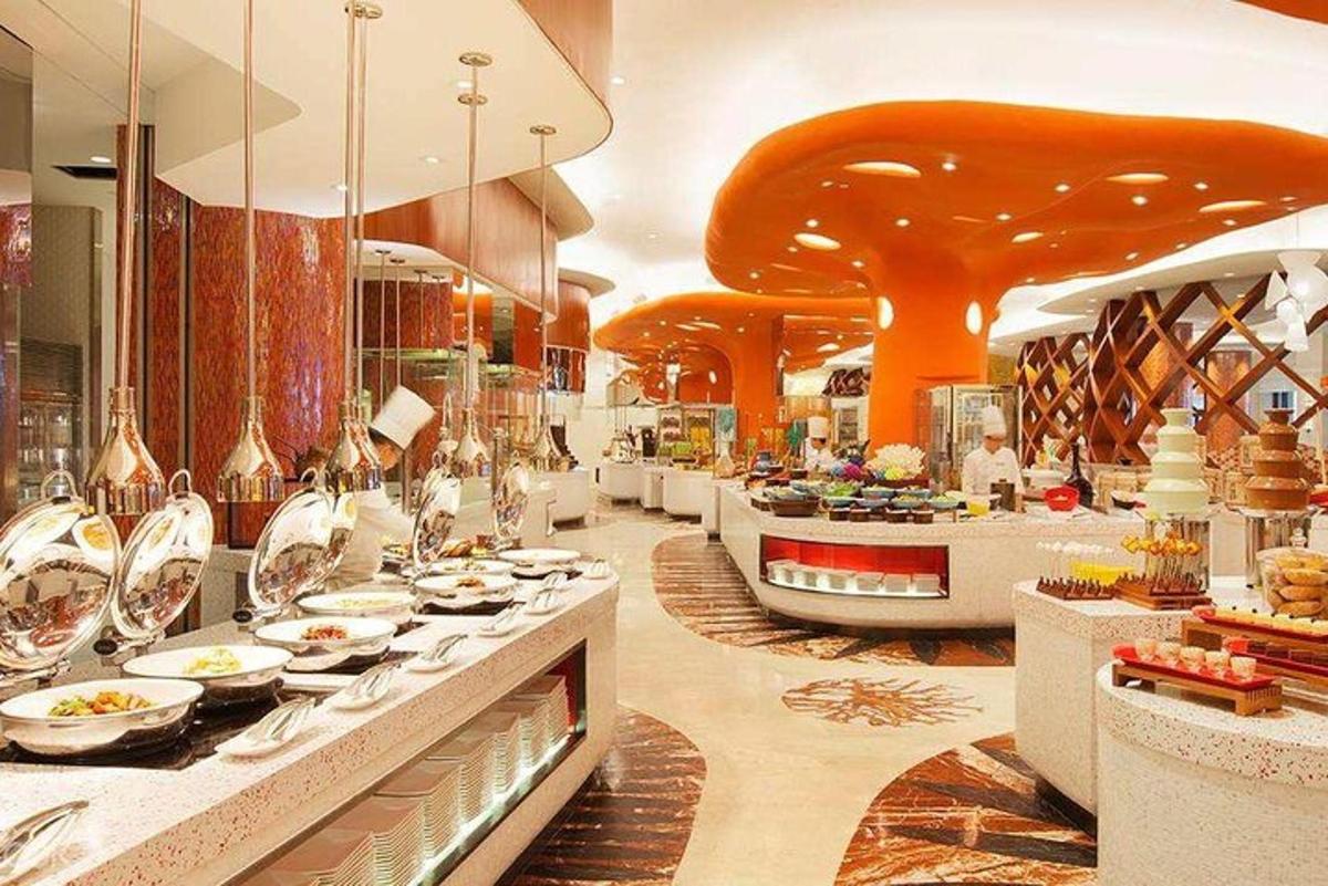a restaurant with a buffet line with plates of food