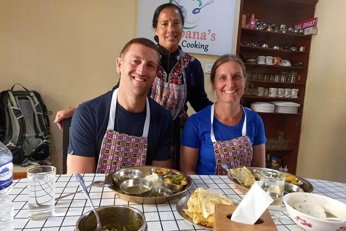 a group of three people sitting at a table with food