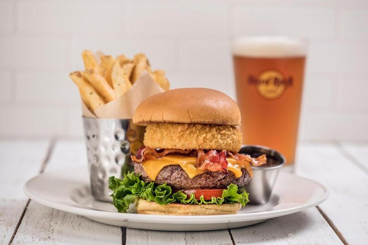 a plate with a hamburger and fries and a glass of beer