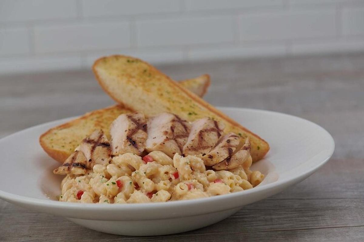 a plate of food with shrimp and bread on a table