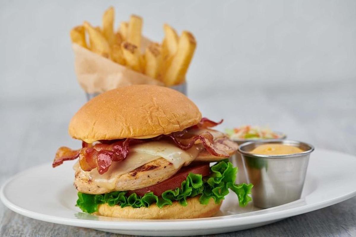 a chicken sandwich and french fries on a plate