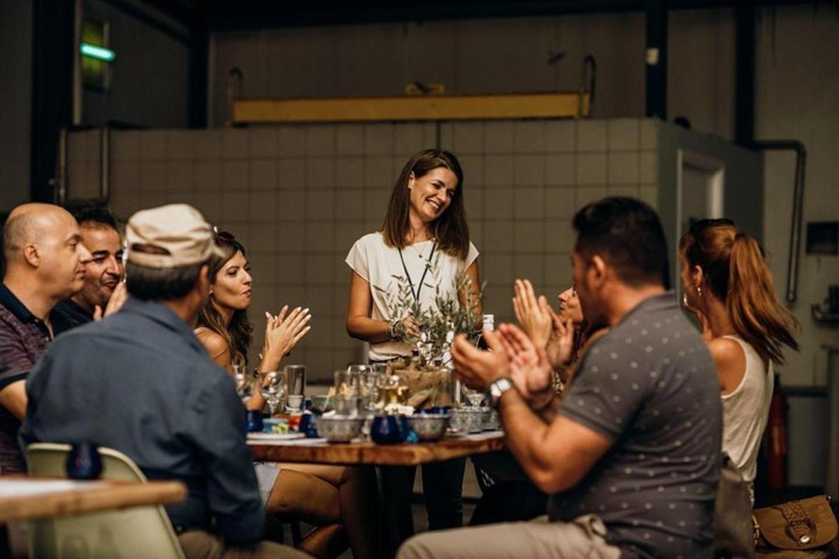 a group of people sitting at a table with their hands up