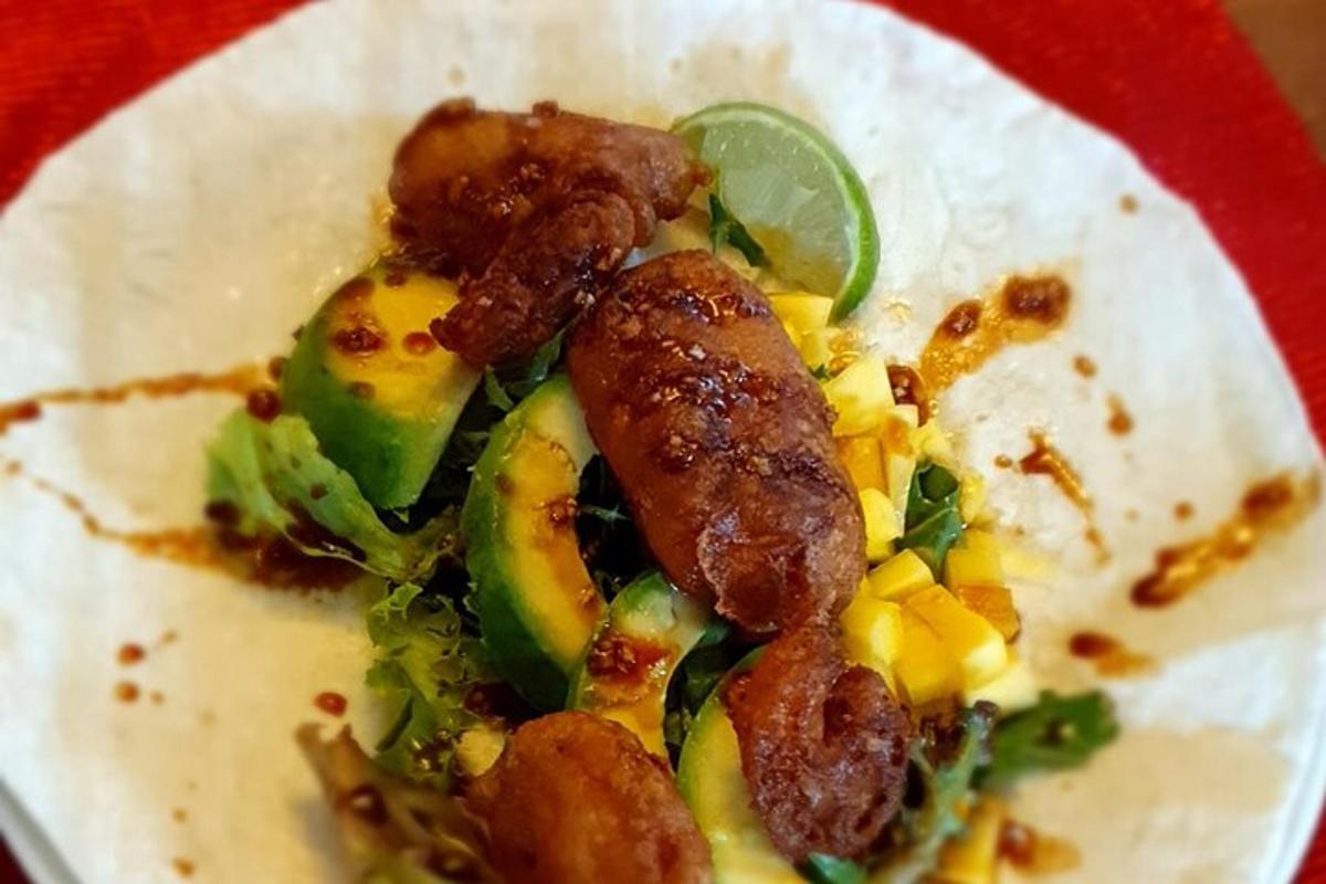 Un plato de comida con carne y verduras encima.