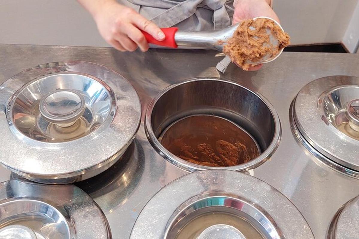 a person cooking food in a pot on a stove