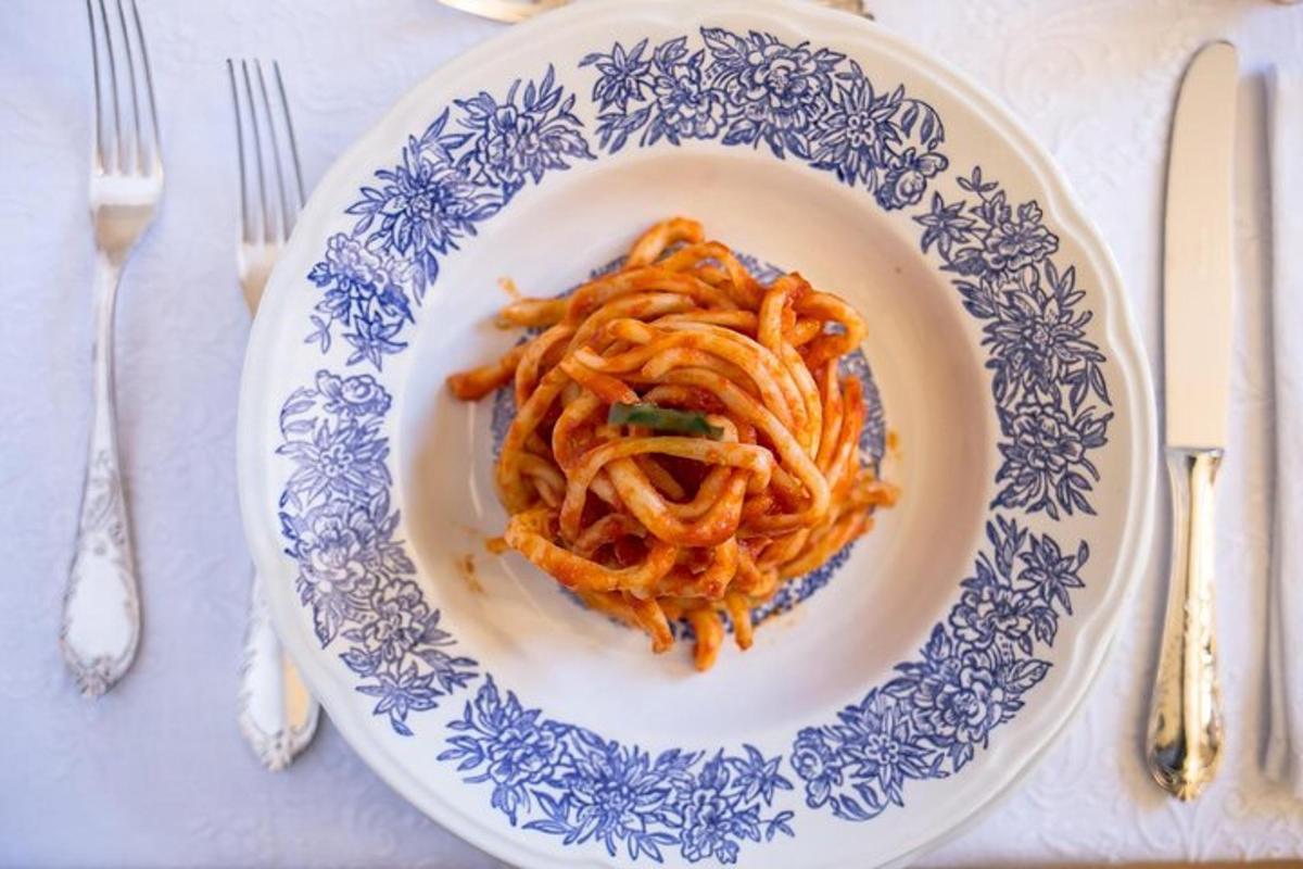 a plate of spaghetti on a blue and white plate