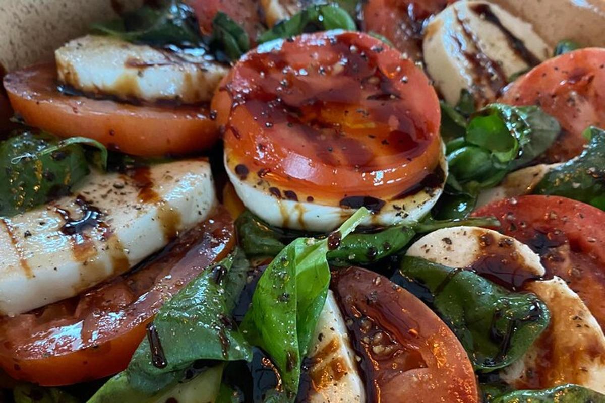 a plate of food with tomatoes and spinach
