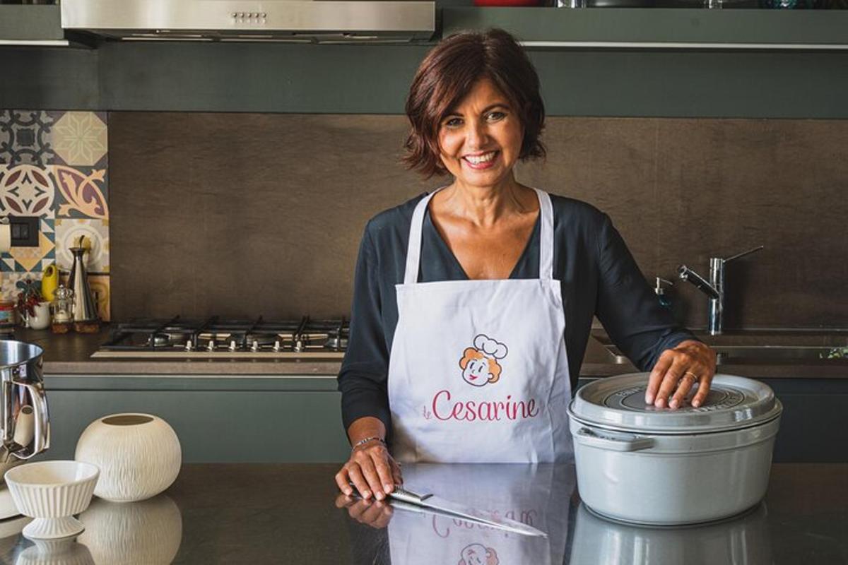 a woman wearing an apron standing in a kitchen