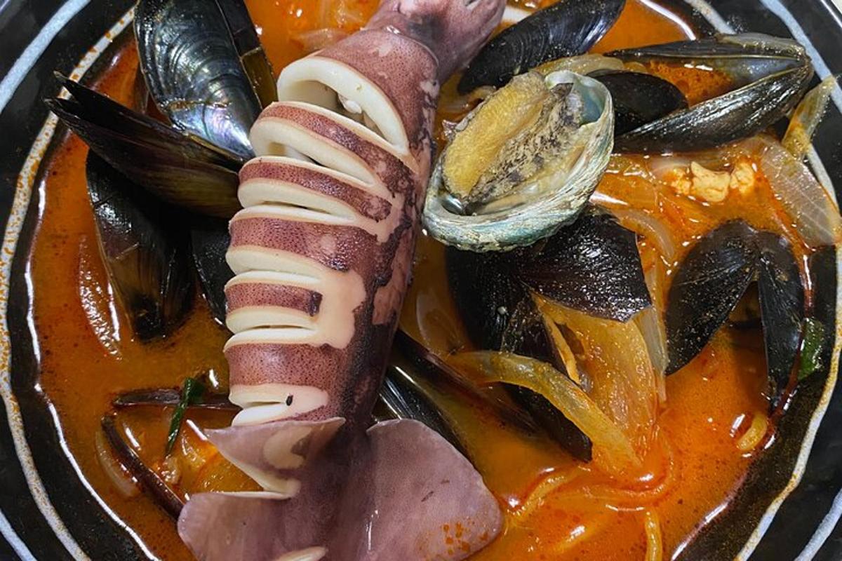 un piatto di cibo con prosciutto e cozze