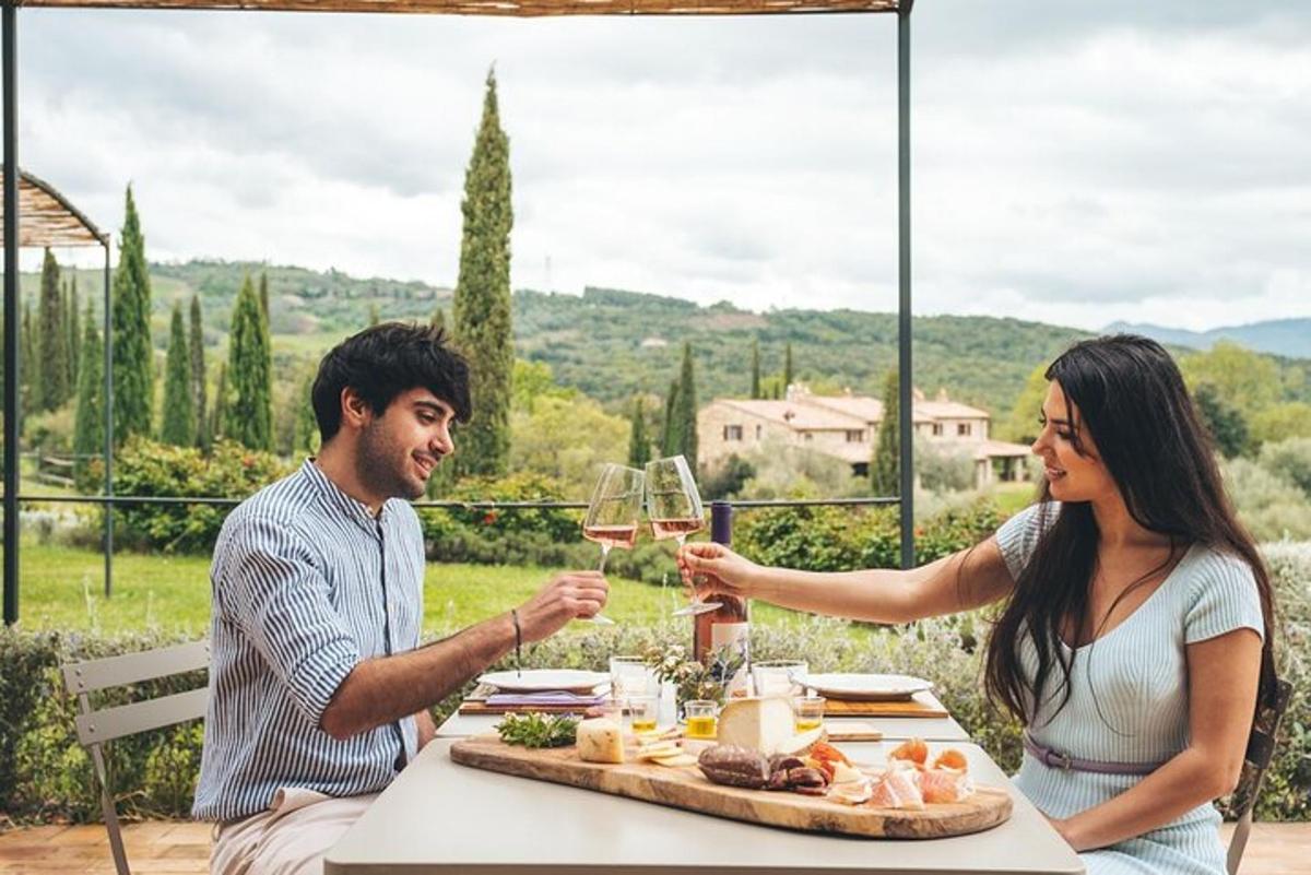 a man and woman sitting at a table with wine glasses
