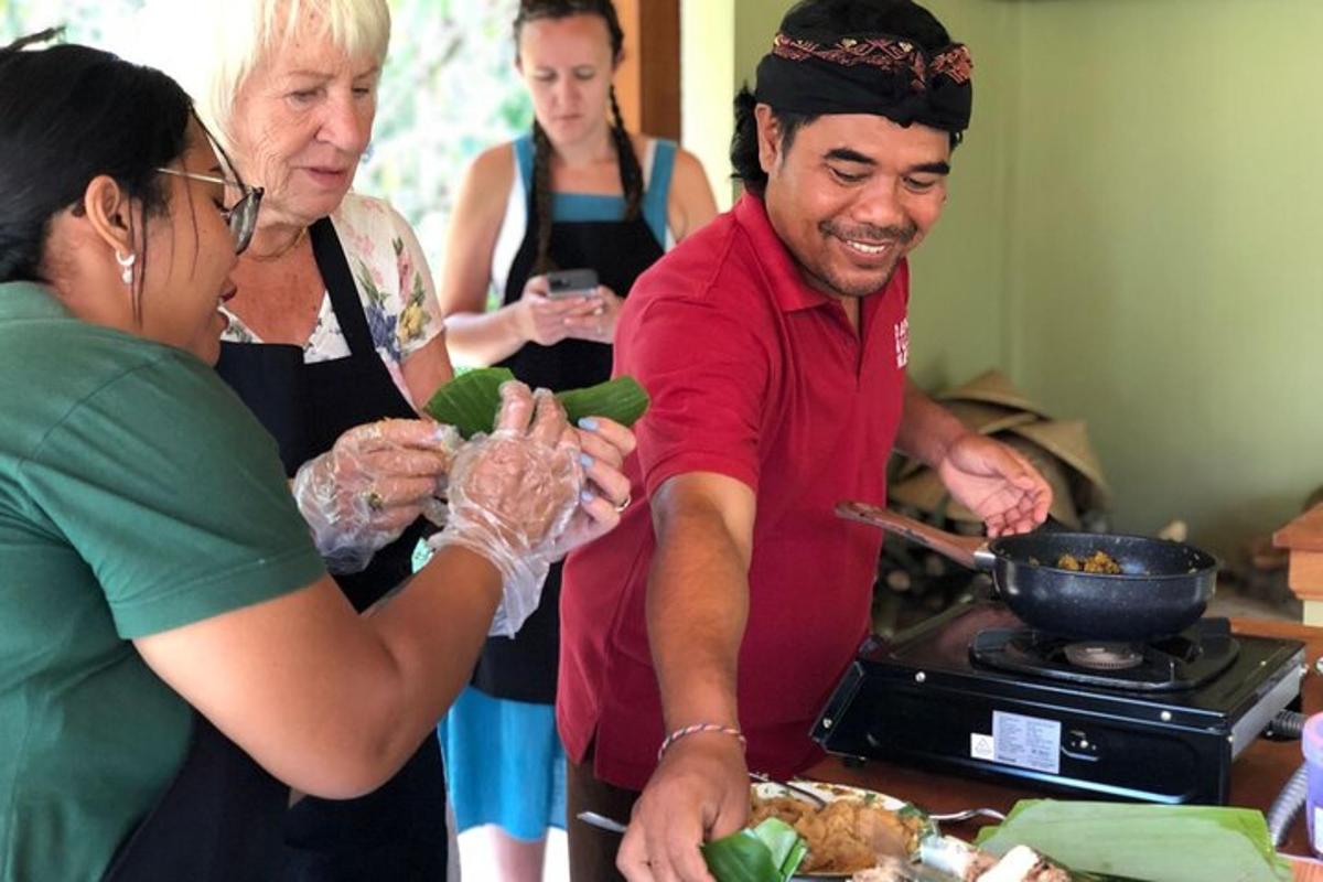 a group of people standing in a kitchen preparing food