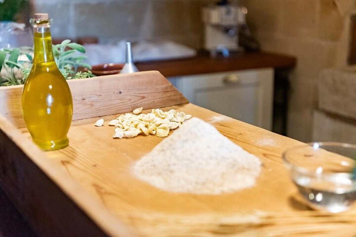 a cutting board with flour and a bottle of oil