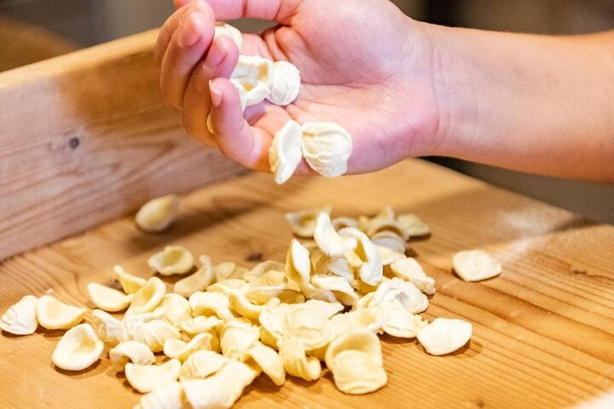 a person cutting up mushrooms on a wooden cutting board