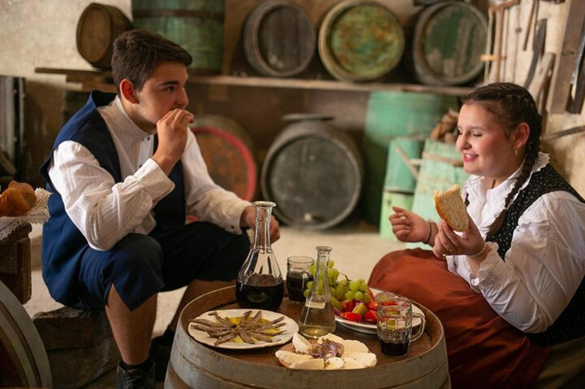 a man and a woman sitting around a table with food