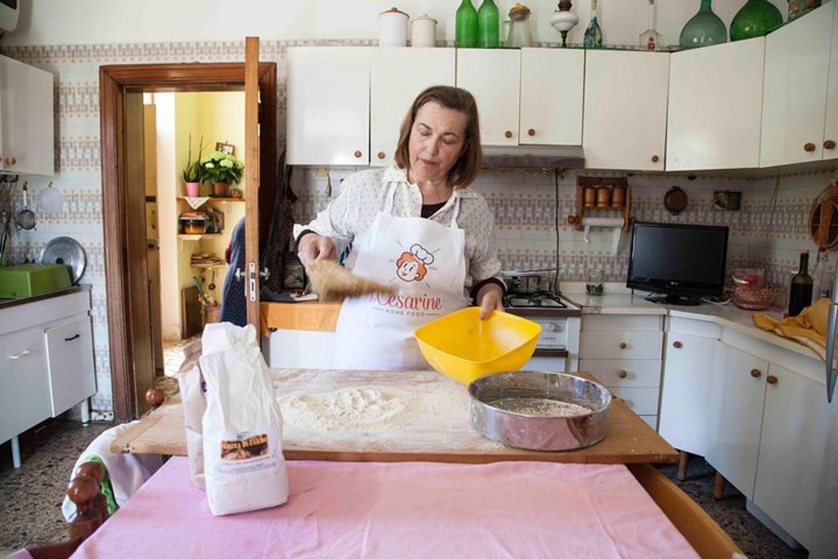 a woman standing in a kitchen preparing food