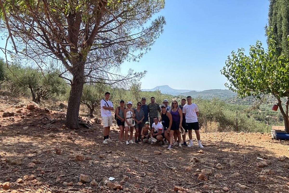 a group of people posing for a picture on a hill
