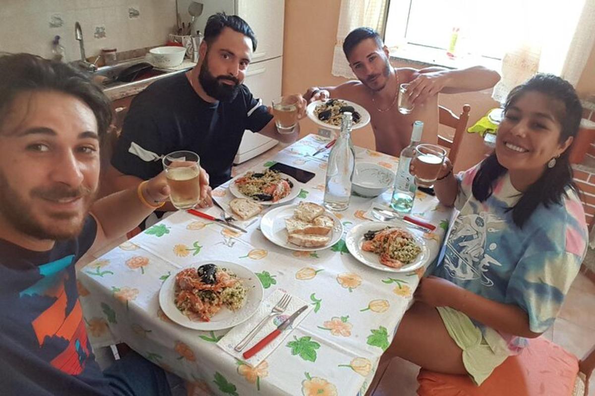 un gruppo di persone sedute attorno a un tavolo che mangiano cibo