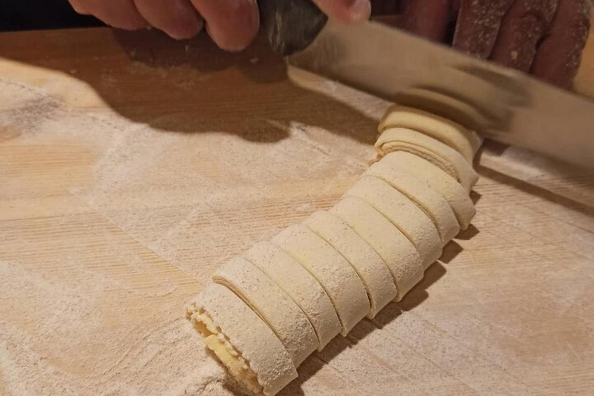a person holding a knife on a cutting board