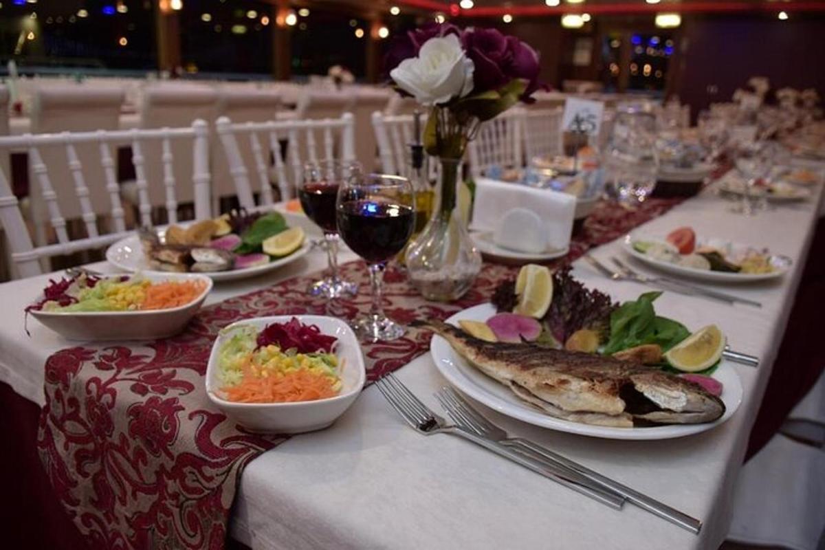 a table with plates of food and glasses of wine
