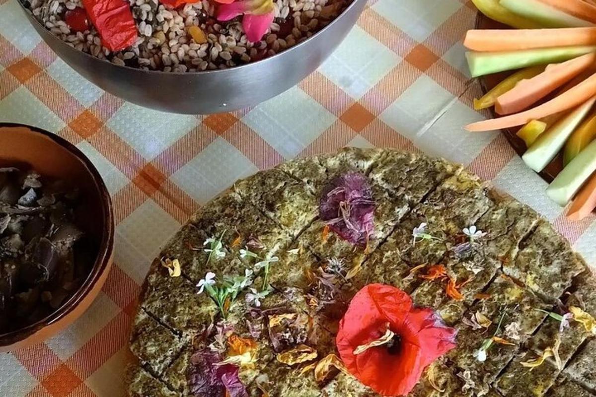 a table topped with two bowls of food and vegetables