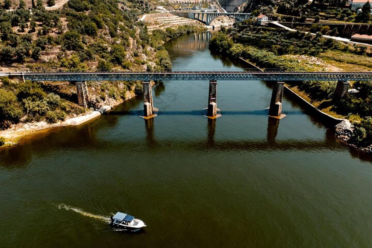 a boat in a river with a bridge
