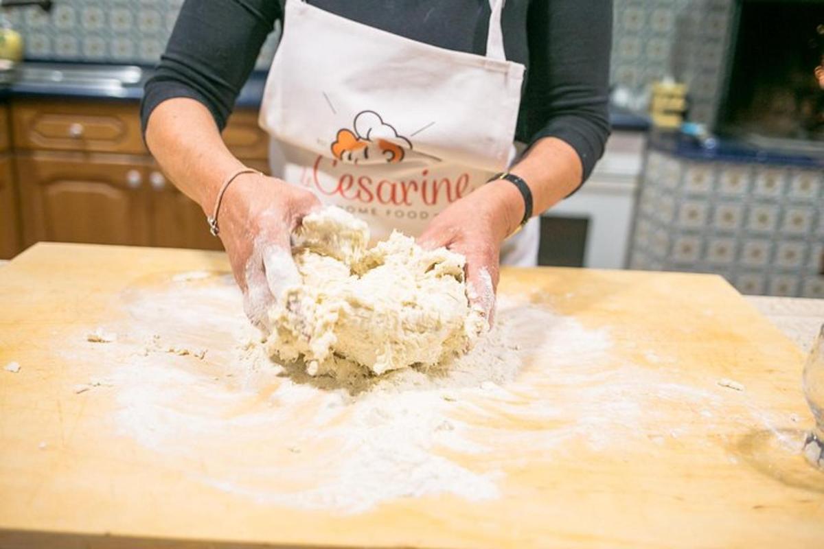 a person is kneading dough on a cutting board